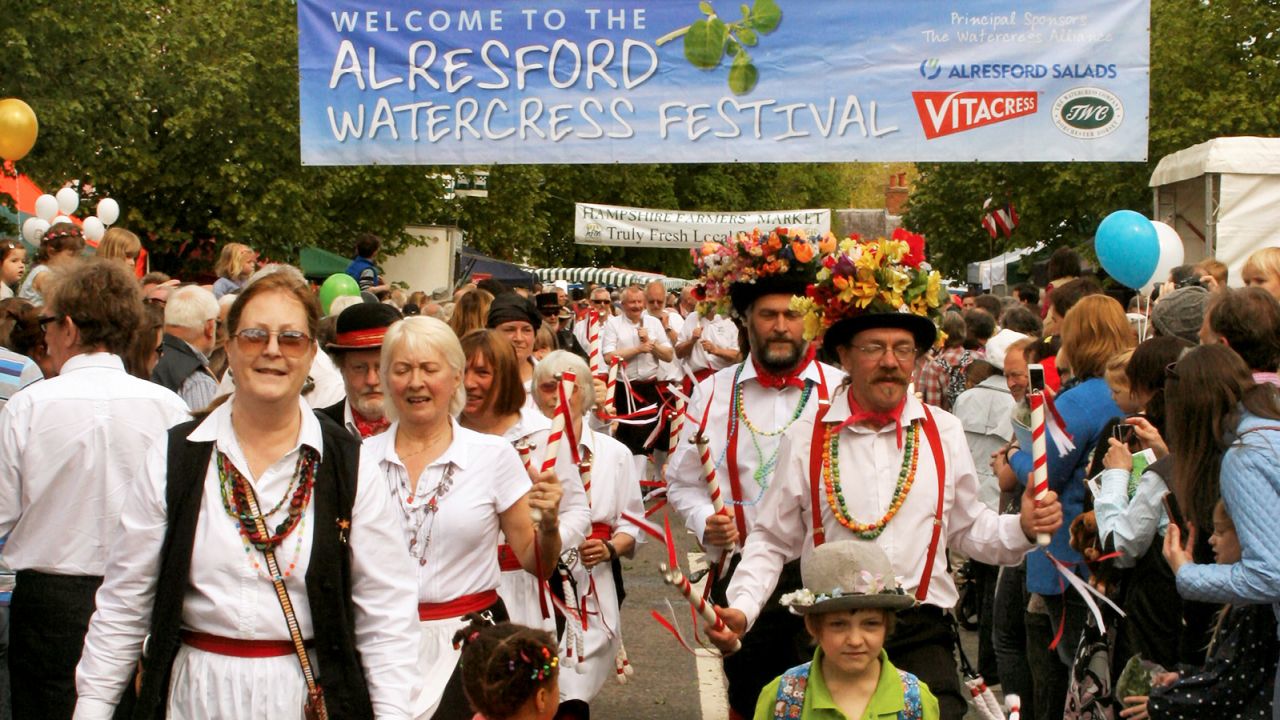 Morris dancers herald the approach of the Watercress King and Queen. 