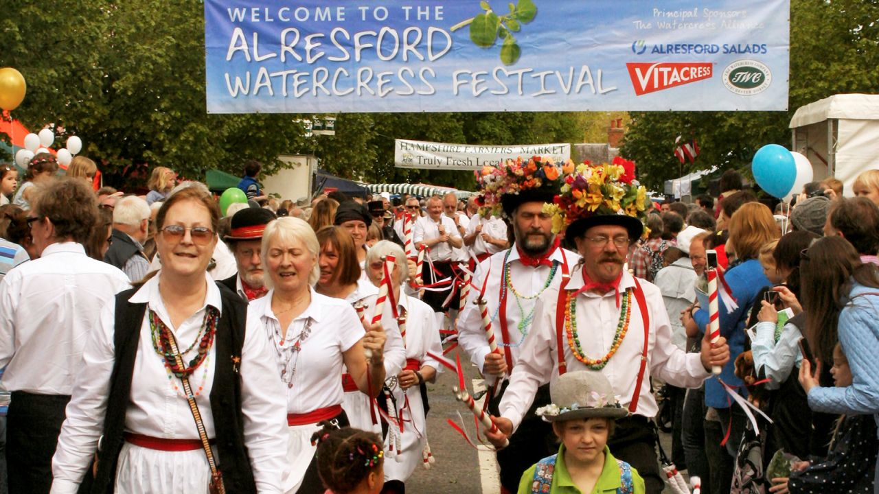 Morris dancers herald the approach of the Watercress King and Queen.