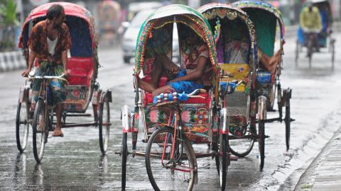 Bangladeshi rickshaw drivers take shelter during a heavy downpour in the capital, Dhaka.