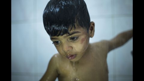 Ahmed showers at the orphanage. He and his three siblings were living with their father in a taxi.