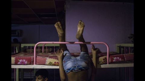 Abdullah Mahdi Kazim, 13, plays on the bunk beds.