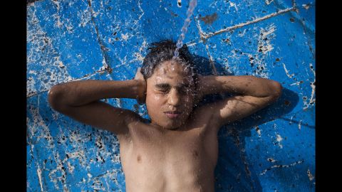 Nayef Nawaf, 11, plays in the water. The orphanage said his parents were killed in an ISIS invasion of his hometown of Fallujah.