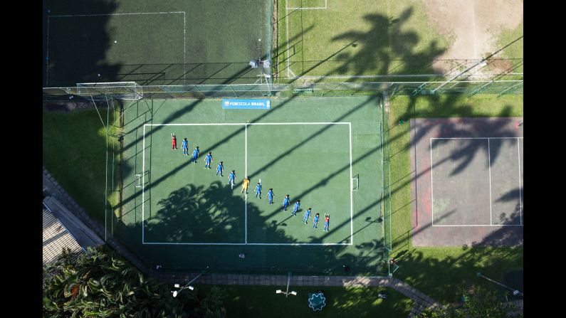 Children lie on a field at the Barcelona Football School in Rio de Janeiro. With 800 young athletes, it is one of the most prestigious sports schools in the city.