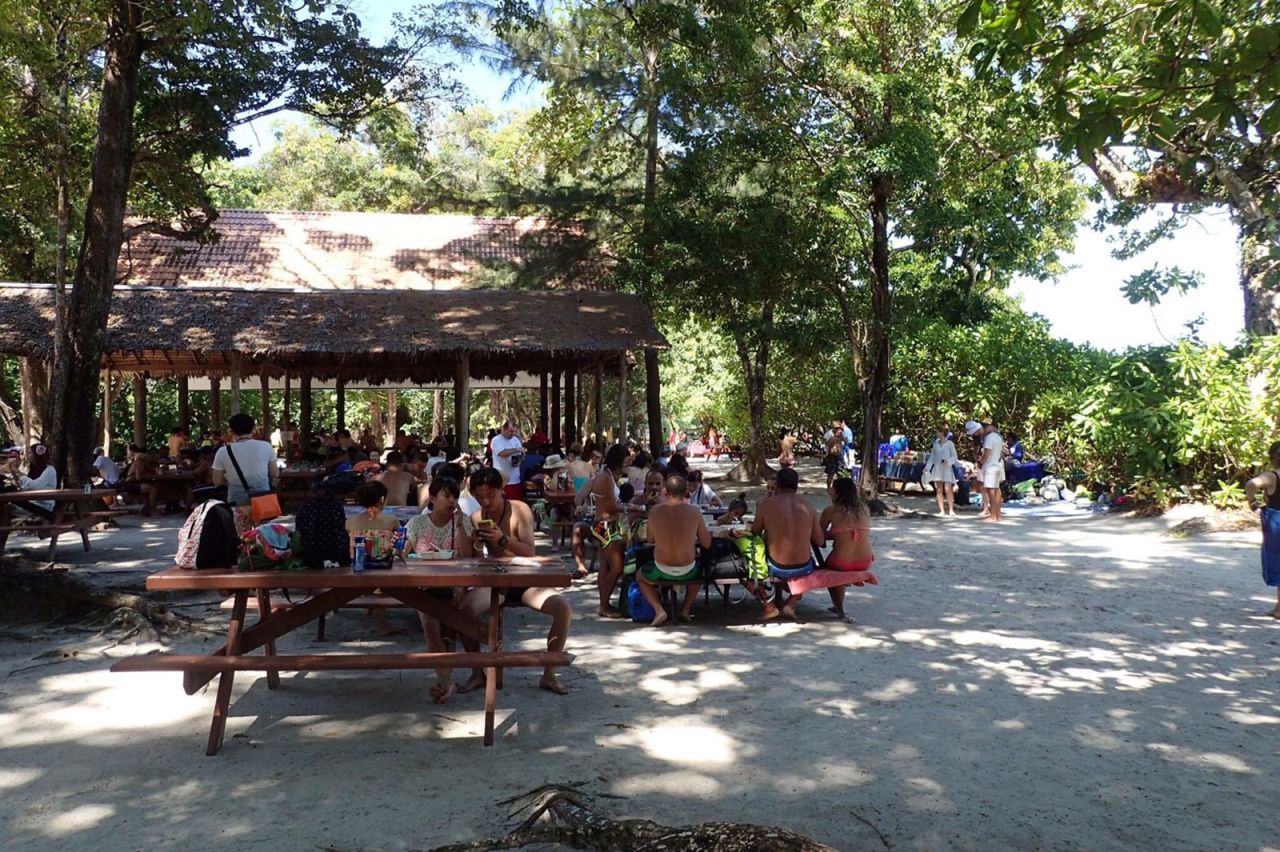 Tourists eat lunch at a picnic area on Koh Tachai.