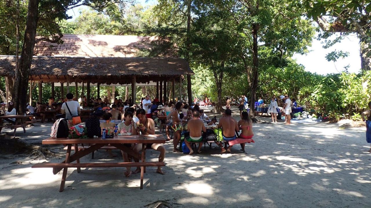 Tourists eat lunch at a picnic area on Koh Tachai.