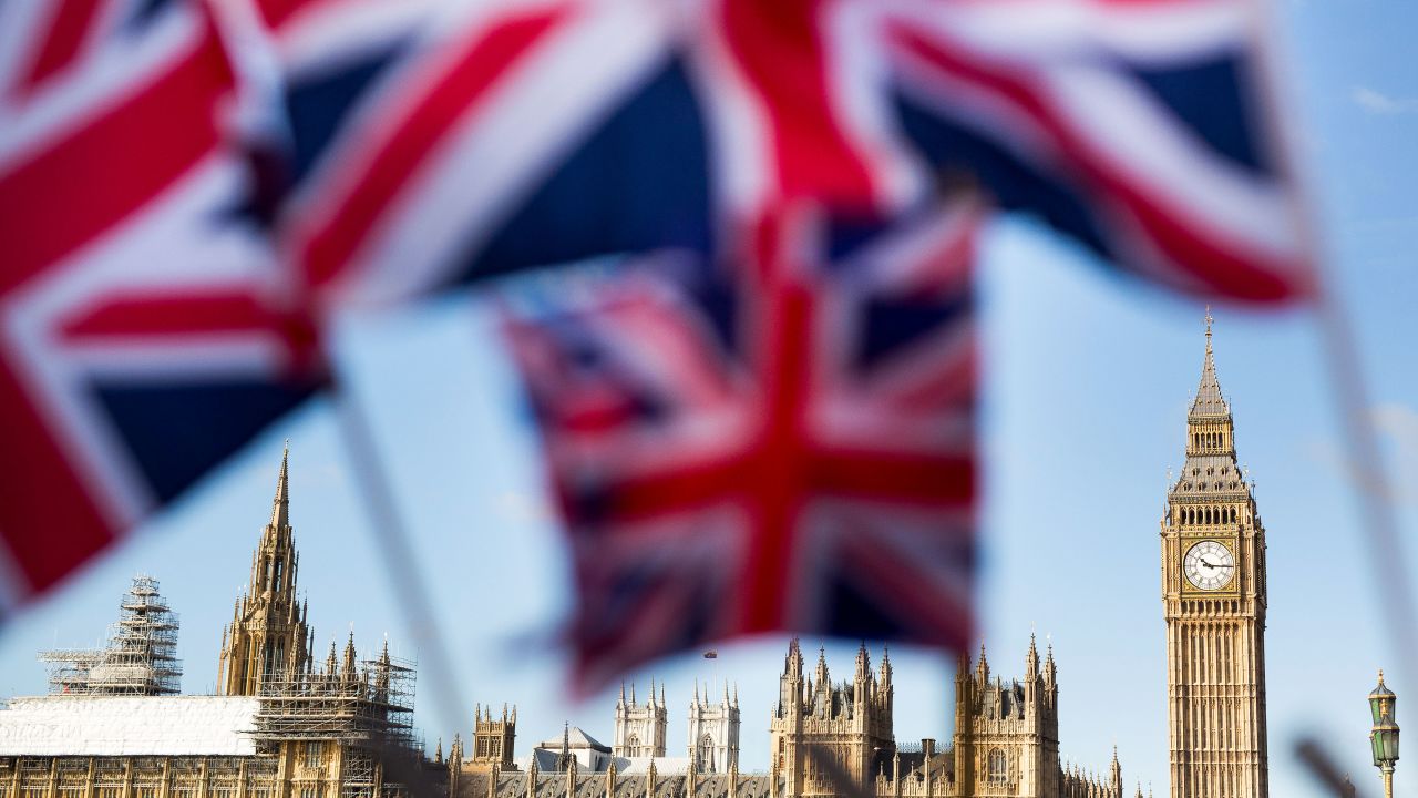 A display of U.K., Union Jack flags fly in front of The Houses of Parliament, in London, U.K., on Monday, February 15, 2016.