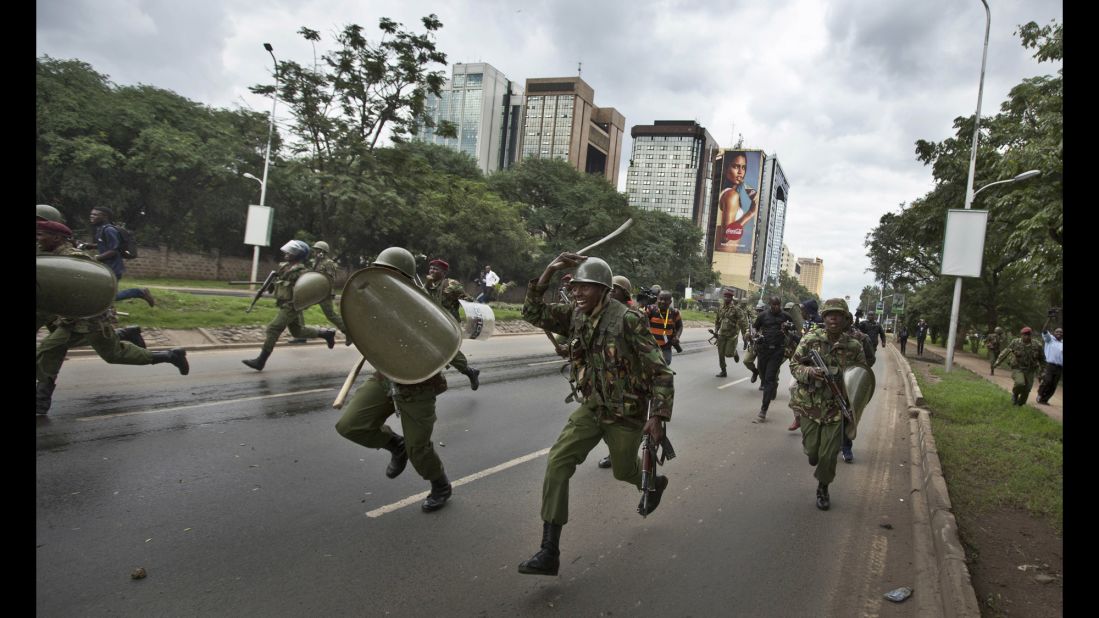 Riot police charge toward opposition supporters during a protest in Nairobi, Kenya, on Monday, May 9.