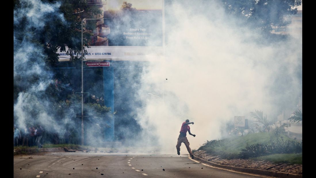 An opposition supporter standing amid clouds of tear gas throws a rock toward riot police during a protest May 9. Curtis said, "Many are hoping that some kind of political resolution of this issue can occur before the protests get further out of hand, but so far there are not many promising indications."