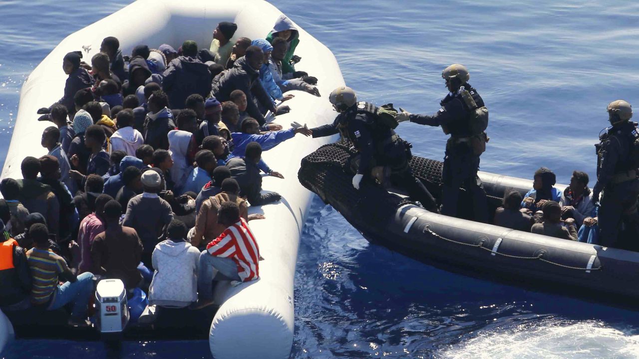 German Navy sailors surround a boat with more than 100 migrants near the German combat supply ship 'Frankfurt am Main' during EUNAVFOR Med, also known as Operation Sophia, in the Mediterranean Sea off the coast of Libya, Tuesday, March 29, 2016. (AP Photo/Matthias Schrader)