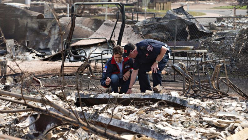 Canadian Prime Minister Justin Trudeau, left, and Fort McMurray Fire Chief Darby Allen look over the devastation during a visit to Fort McMurray on May 13.