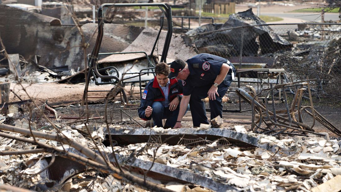 Canadian Prime Minister Justin Trudeau, left, and Fort McMurray Fire Chief Darby Allen look over the devastation during a visit to Fort McMurray on May 13.
