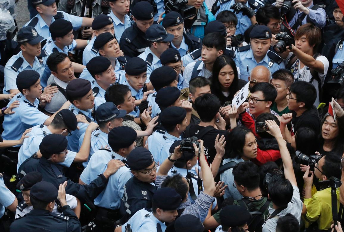 Hong Kong police clash with anti-Beijing protesters who took to the streets during the three-day visit of senior Chinese official Zhang Dejiang on Wednesday, May 18, 2016. 