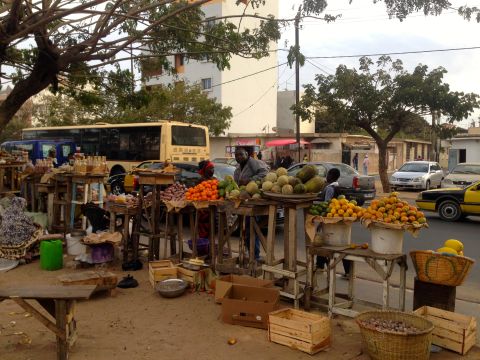 Back in the capital, the hustle of commerce extends to Dakar's sidewalks.