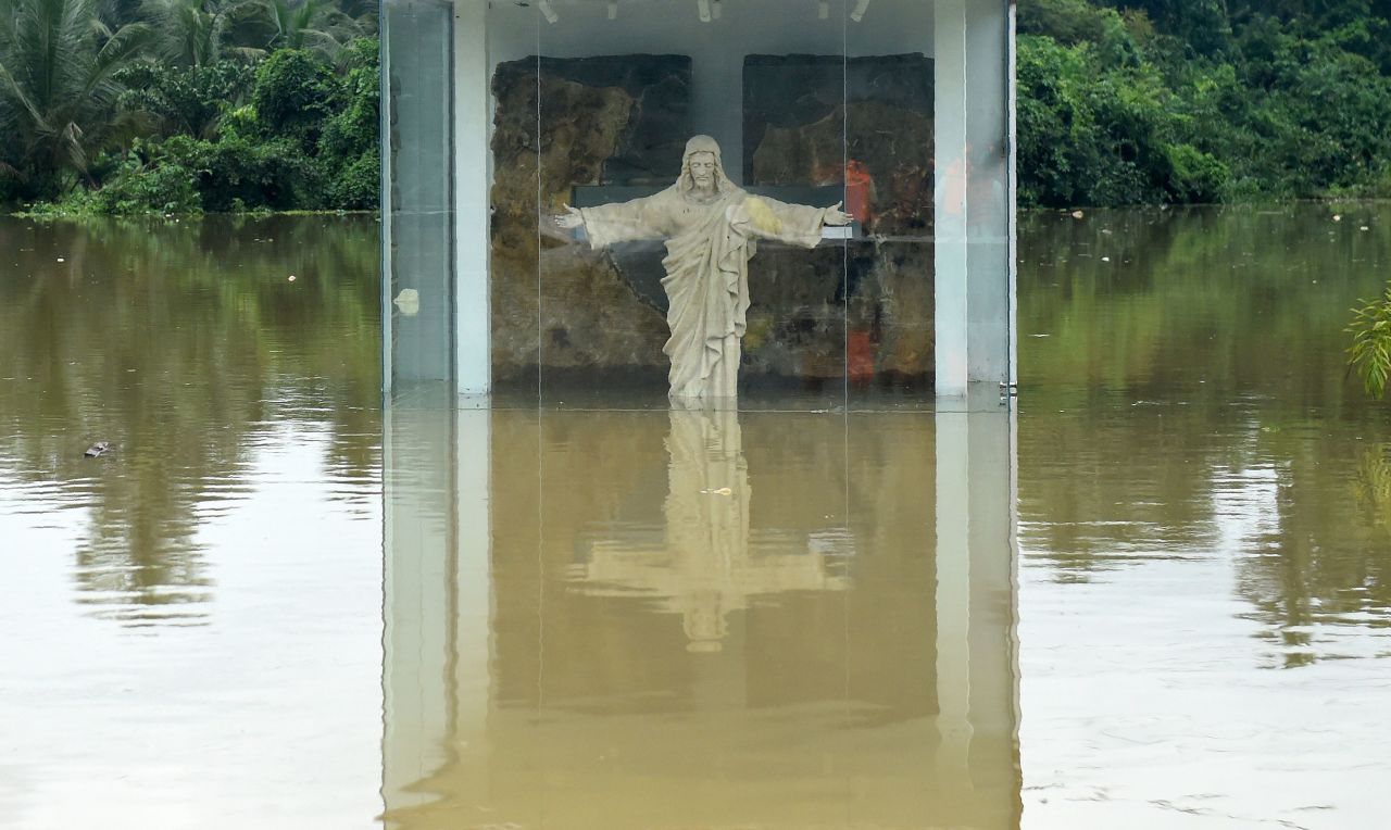 A roadside statue of Jesus Christ is submerged by floodwaters in Pugoda, about 35 km (22 mi) from Colombo on May 17.