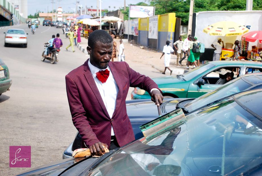 Abdulahi Olatoyan wears sharp suits while working as a car window washer in Abeokuta, southwest Nigeria. "I didn't want to be wandering around the streets doing nothing" he says. 