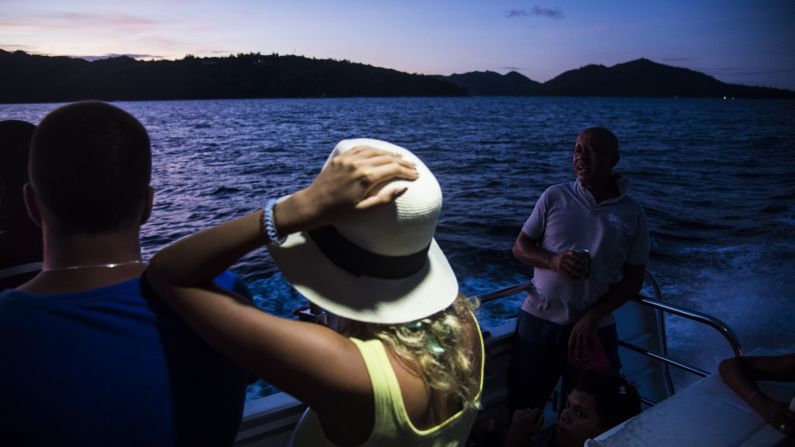 Ferry passengers watch the sun set as they leave the island of Praslin in the Seychelles. Praslin's <a href="index.php?page=&url=https%3A%2F%2Fwww.cnn.com%2F2016%2F02%2F17%2Ftravel%2Ftripadvisor-best-beaches-world-feat%2Findex.html" target="_blank">Anse Lazio</a> was recently named the fourth-best beach in the world by TripAdvisor. 