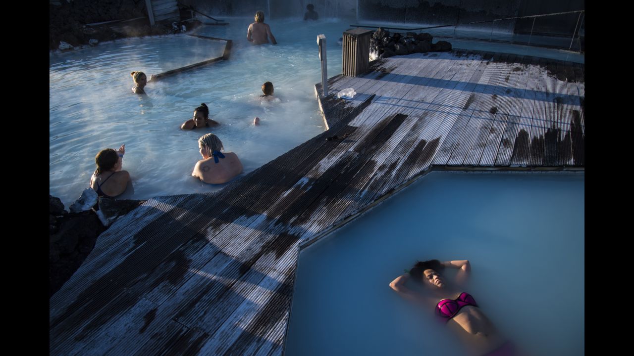 A woman floats in the Blue Lagoon, a geothermal spa and one of Iceland's most popular attractions. The water's temperature averages 37-39 degrees Celsius (98.6-102.2 Fahrenheit).