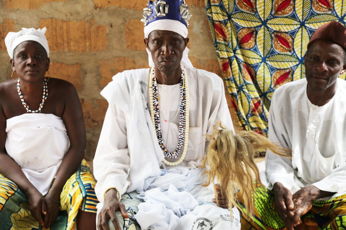 A voodoo priest holds a wand made of horse hair in a convent.