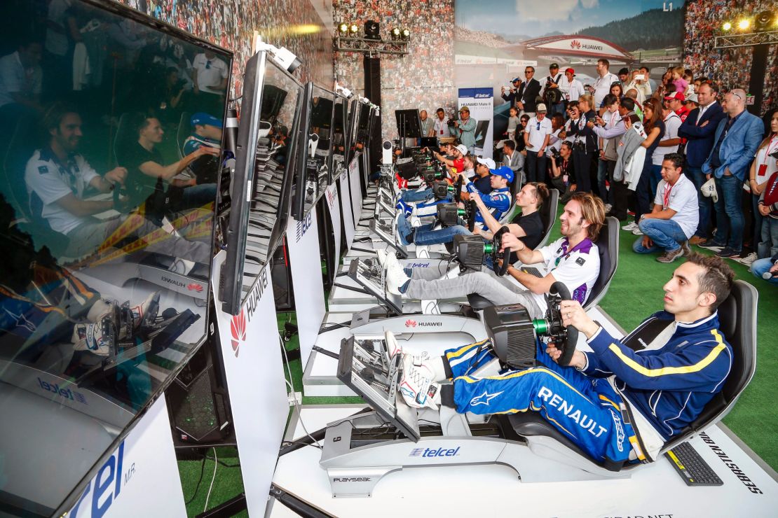 Formula E drivers race against the public on simulators before the real action gets underway.
