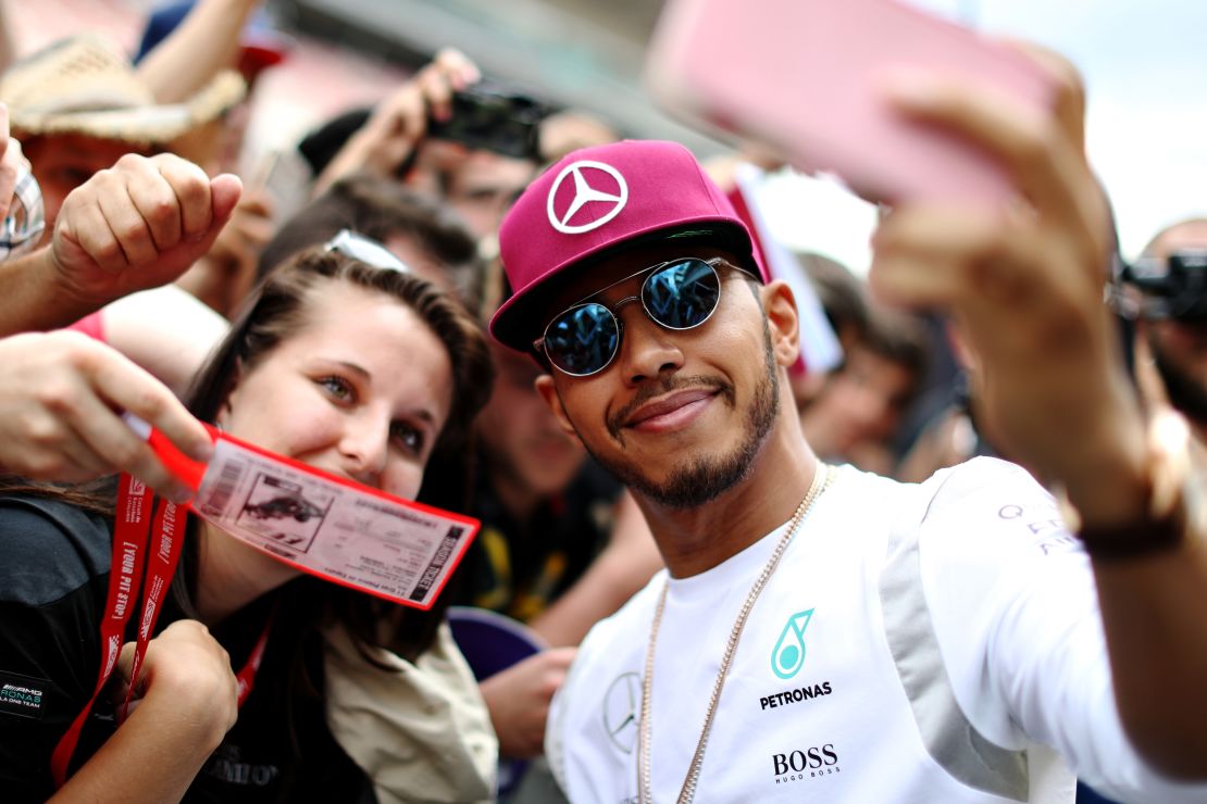 Reigning world champion Lewis Hamilton takes a selfie with fans at the Spanish GP.  