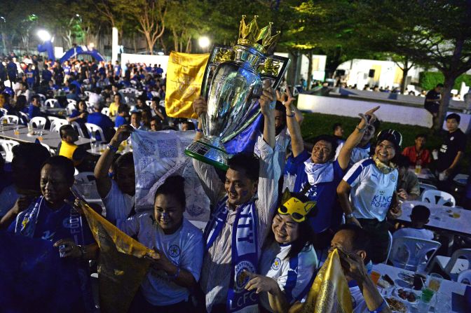 Leicester fans in Bangkok pose with a replica Premier League trophy before a live screening of the Leicester vs. Everton match on the penultimate weekend of the Premier League season. Leicester, confirmed as champion when rival Tottenham failed to win earlier that week, triumphed 3-1 to add even more gloss to their remarkable triumph.