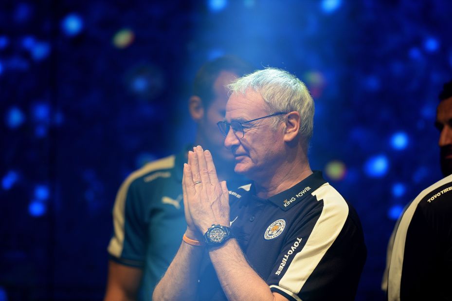 Ranieri offers a traditional Thai greeting as he takes part in a presentation of the  Premier League trophy at the headquarters of King Power, Srivaddhanaprabha's company.