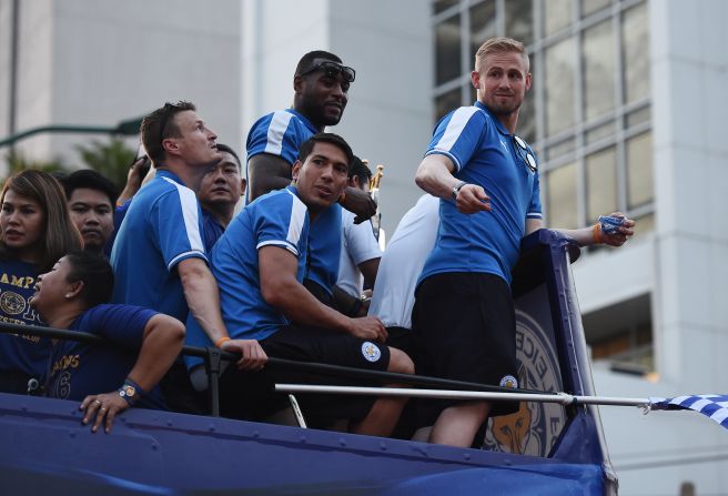 Leicester's Robert Huth (left), Wes Morgan (top center), Leonardo Ulloa (bottom center) and Kasper Schmeichel (right) take in the acclaim during the bus tour. Star striker Jamie Vardy and midfielder Danny Drinkwater were absent after international call-ups by England coach Roy Hodgson.