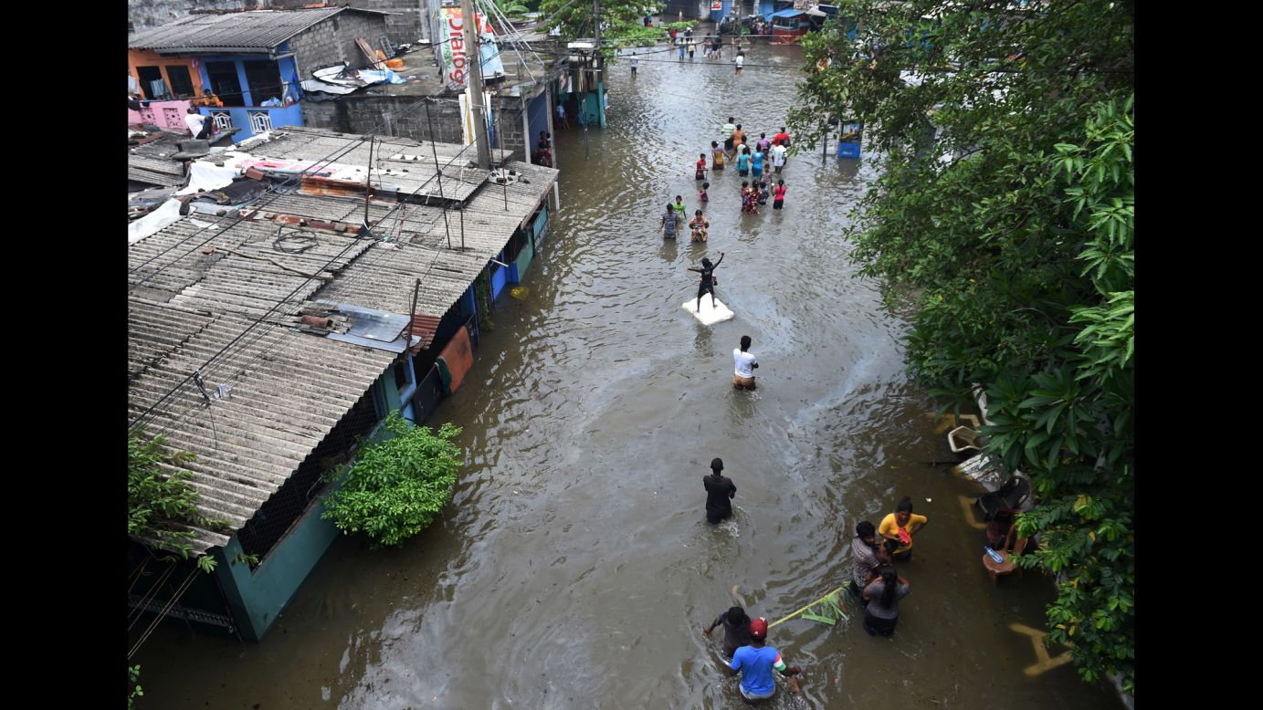 Residents make their way through floodwaters in Colombo, Sri Lanka, on Thursday, May 19. Hundreds of thousands of people <a href="http://www.cnn.com/2016/05/18/asia/sri-lanka-flood/" target="_blank">have been forced from their homes</a> after a major storm hammered the country. At least 37 people have died and 21 are missing after three days of incessant rains that came just a couple weeks before the monsoon season.