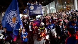 Supporters of Leicester City wave flags and cheer as the team's football players and owners parade in an open-bus with the Premier League trophy through Bangkok on May 19, 2016.
Newly crowned English Premier League champions Leicester City received a royal seal of approval on May 19 at Bangkok's Grand Palace, with the Thai-owned team presenting its trophy to a portrait of the king before a bus parade through the capital. / AFP / CHRISTOPHE ARCHAMBAULT        (Photo credit should read CHRISTOPHE ARCHAMBAULT/AFP/Getty Images)