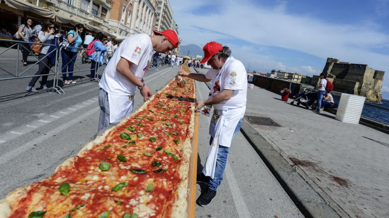 Pizza makers in Naples, Italy, help set a Guinness World Record for longest pizza on Wednesday, May 18. The wood-fired pizza was 6,082 feet long (1.15 miles).