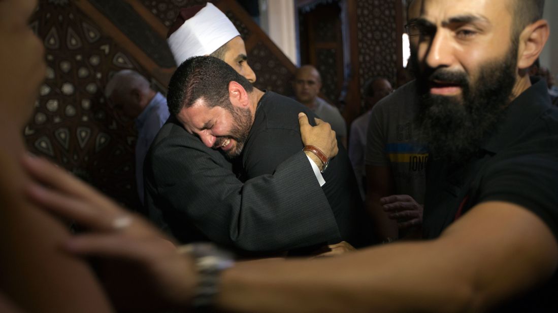 Samir Abdel Bary, imam of Cairo's al Thawrah Mosque, consoles Tarek Abu Laban, who had four relatives on the flight, on Friday, May 20. 