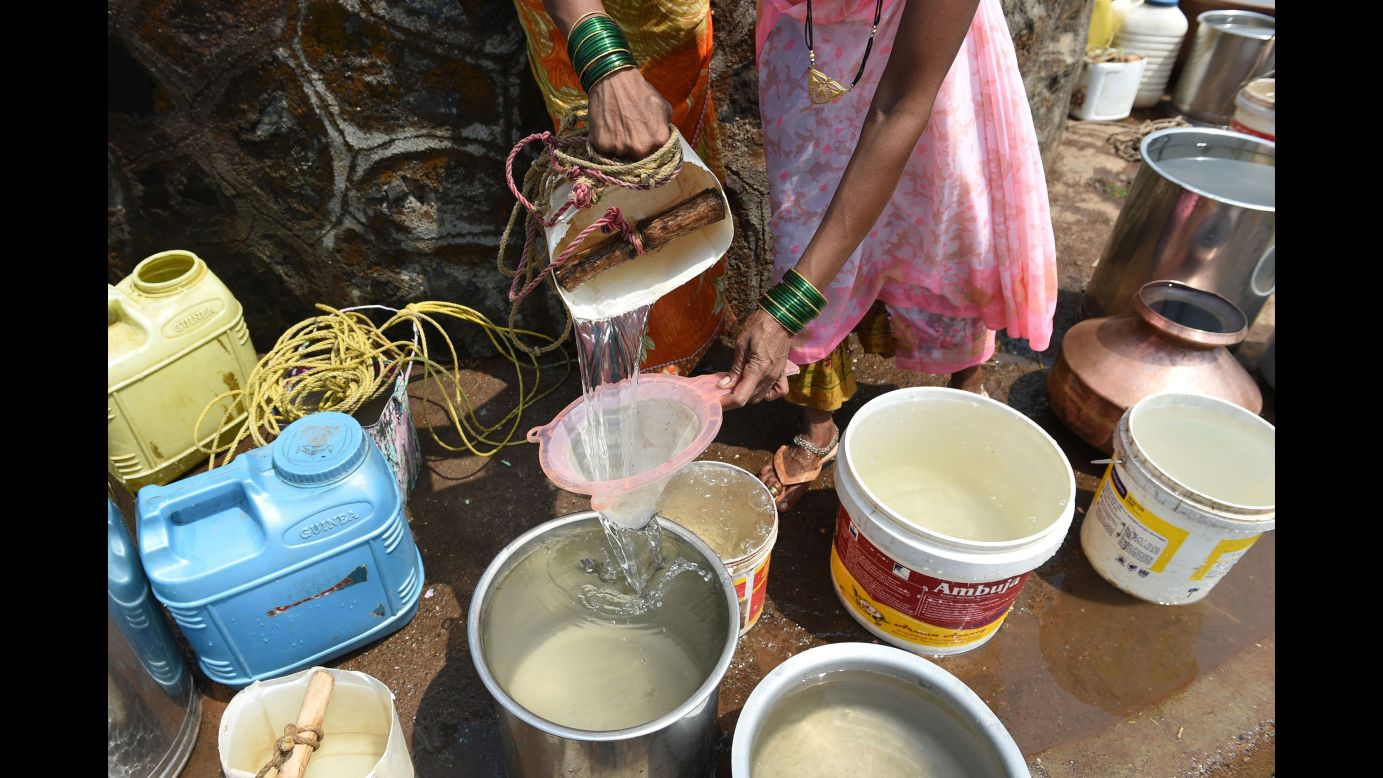 A villager filters her water through a sieve in Shahapur.