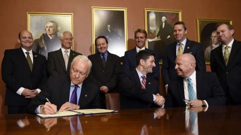 House Speaker Paul Ryan, center, shakes hands with U.S. Rep. Kevin Brady, chairman of the House Ways and Means Committee, as U.S. Sen. Orrin Hatch signs the American Manufacturing Competitiveness Act on Wednesday, May 18.