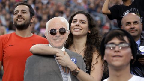 A young woman holds a cardboard cutout of U.S. Sen. Bernie Sanders during the presidential candidate's rally in Carson, California, on Tuesday, May 17.