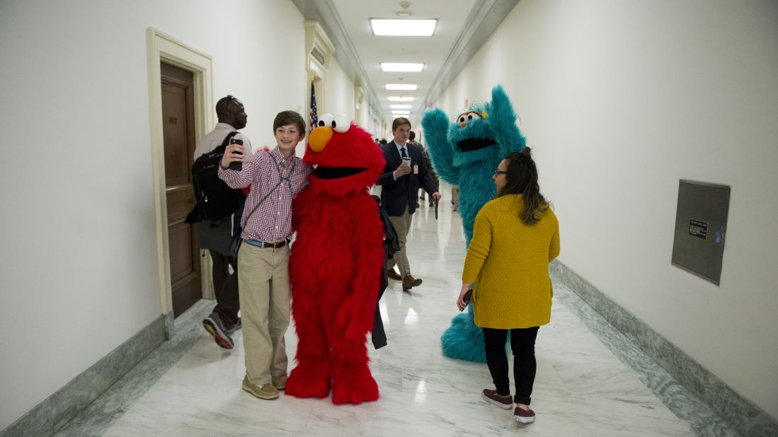 "Sesame Street" characters Elmo and Rosita pose with visitors in the halls of the Rayburn House Office Building after attending a USO event in Washington on Tuesday, May 17.