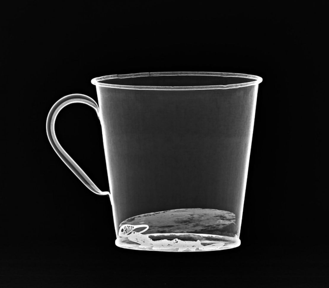 An X-ray shows how the ring and necklace were concealed at the base of the mug.