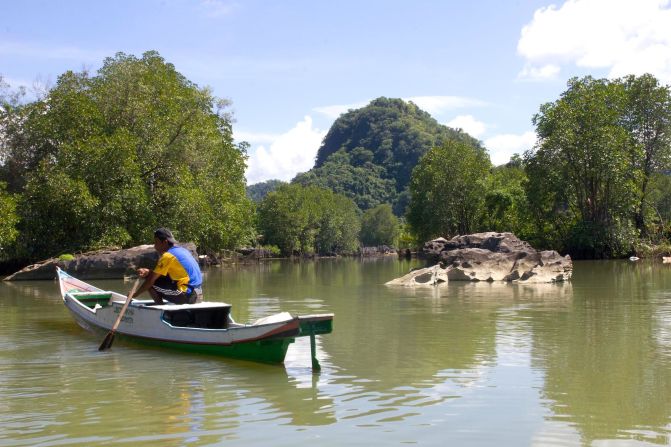 A boatman awaits passengers in Rammang-Rammang. 