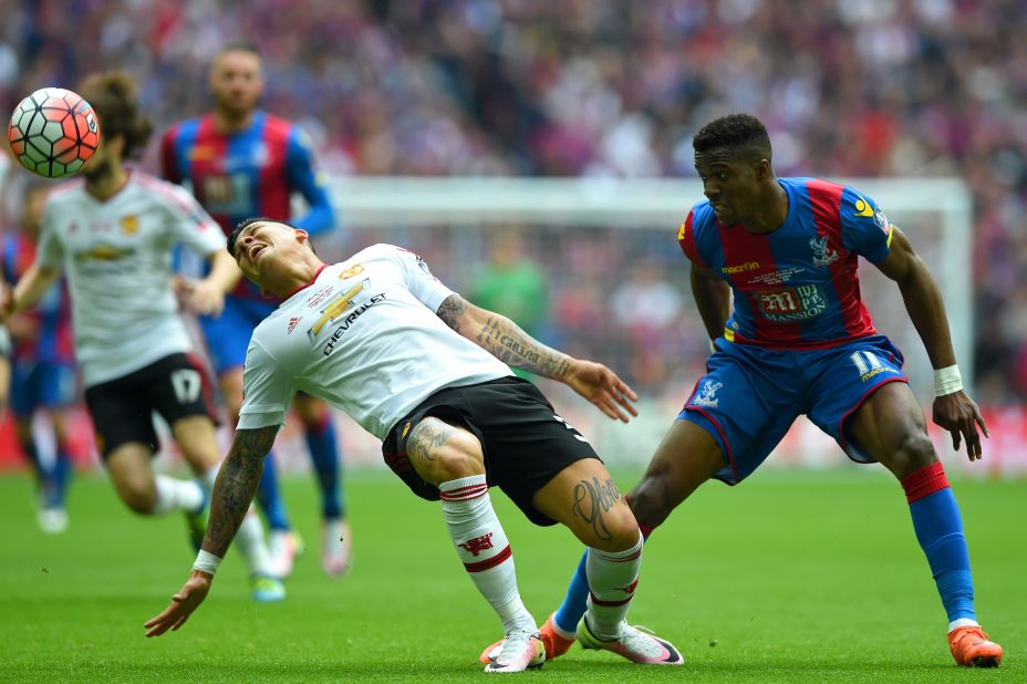 Marcos Rojo (R) gestures after coming into contact with Wilfried Zaha of Crystal Palace.