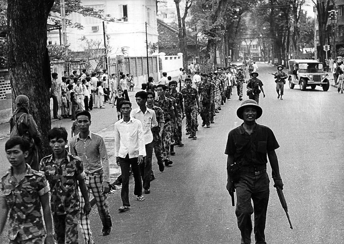 Captured U.S.-backed South Vietnamese Army soldiers are escorted by Vietnamese communist soldiers in Saigon, April 30, 1975,