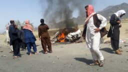 This photograph taken on May 21, 2016 shows Pakistani local residents gathering around a destroyed vehicle hit by a drone strike in which Afghan Taliban Chief Mullah Akhtar Mansour was believed to be travelling in the remote town of Ahmad Wal in Balochistan, around 160 kilometres west of Quetta.
Afghan authorities scrambled May 22 to confirm the fate of Taliban leader Mullah Akhtar Mansour after US officials said he was likely killed in drone strikes -- a potential blow to the resurgent militant movement.
 / AFP / -        (Photo credit should read -/AFP/Getty Images)