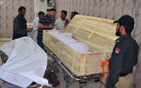 Pakistani security officials and hospital staff oversee two bodies at the Quetta morgue on May 22.