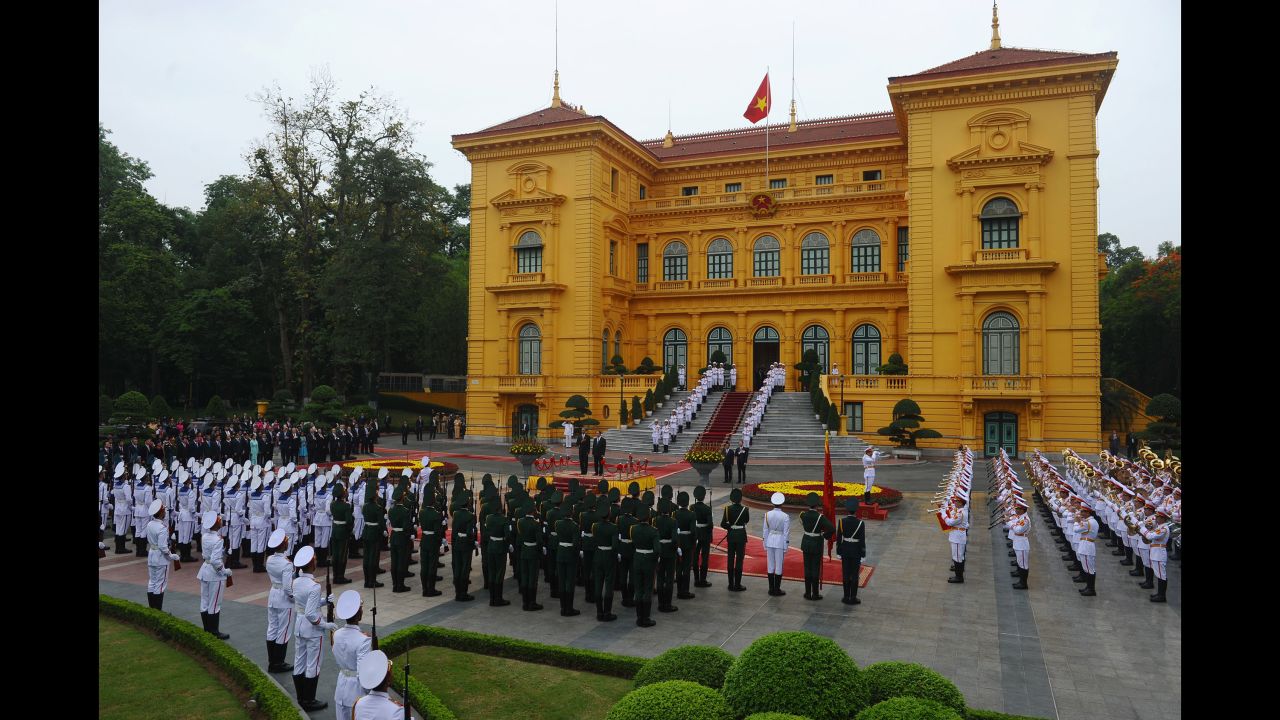 The two Presidents listen to their countries' national anthems during a welcoming ceremony at the Presidential Palace in Hanoi on May 23.