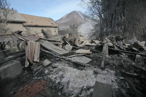 A scorched home is seen on Sunday, May 22, 2016 after it was hit by the eruption of Indonesia's Mount Sinabung. The volcano unleashed hot clouds of ash Saturday, May 21, killing at least seven people in the western province of North Sumatra.