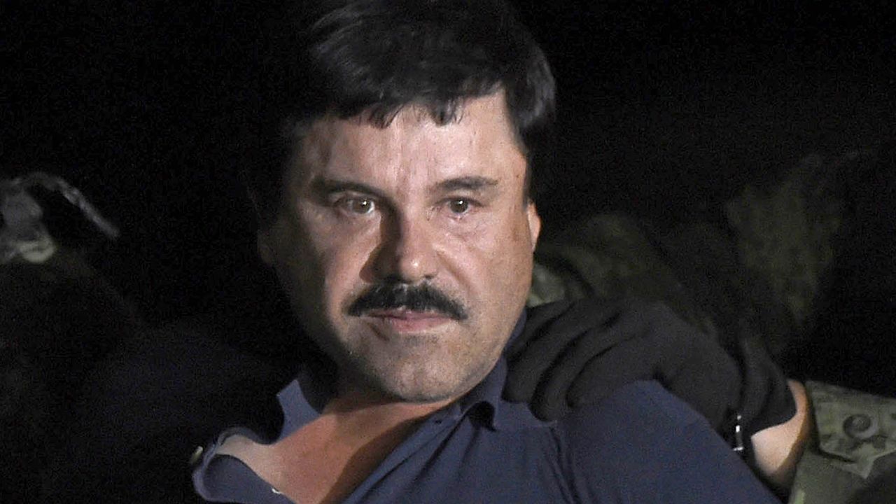 Drug kingpin Joaquin "El Chapo" Guzman is escorted into a helicopter at Mexico City's airport on January 8, 2016