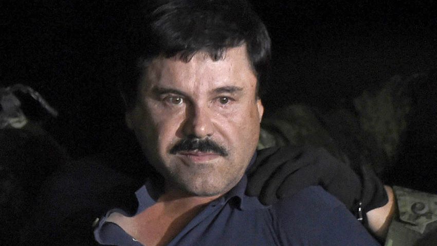 Drug kingpin Joaquin "El Chapo" Guzman is escorted into a helicopter at Mexico City's airport on January 8, 2016 