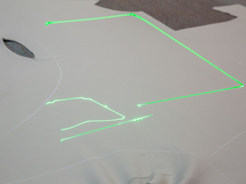 Computerized lasers are used to precisely cut each leather piece. 