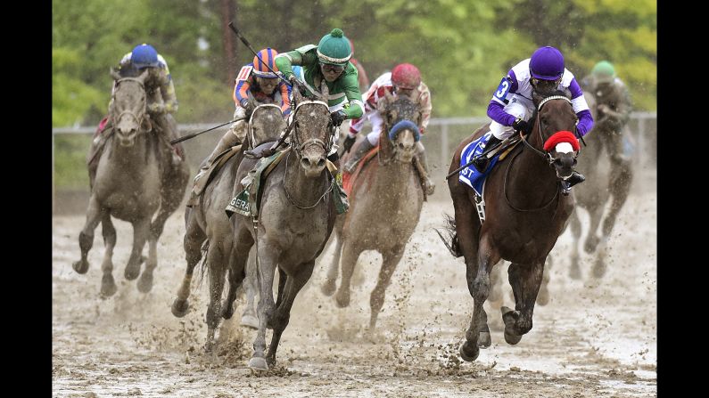 Jockey Kent Desormeaux, in green, <a href="index.php?page=&url=http%3A%2F%2Fwww.cnn.com%2F2016%2F05%2F21%2Fsport%2Fpreakness-stakes-exaggerator%2Findex.html" target="_blank">rides Exaggerator to victory</a> in the Preakness Stakes on Saturday, May 21. The track in Baltimore was very muddy because of a cold rain that fell all day.