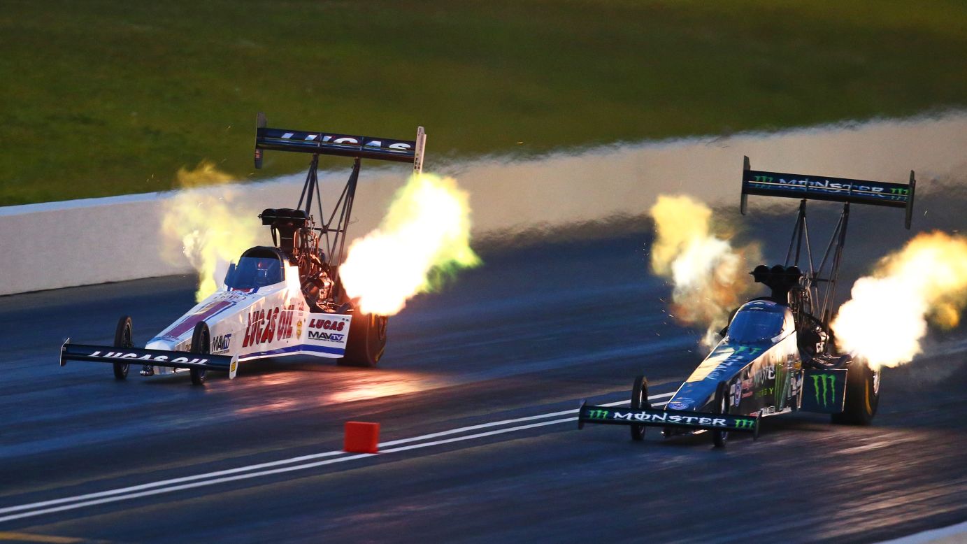 Drag racer Brittany Force, right, speeds past Richie Crampton during a record-breaking qualifying run at the Kansas Nationals on Friday, May 20. Force set a national Top Fuel record of 3.676 seconds.