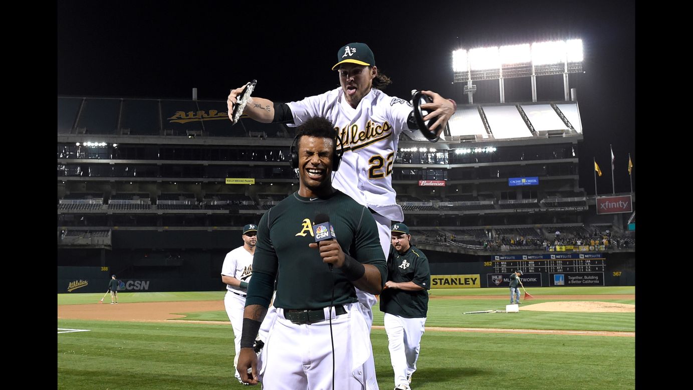 Oakland's Josh Reddick prepares to smash two pies into the face of teammate Khris Davis as Davis gives a television interview on Tuesday, May 17. Davis had just hit a walk-off grand slam to beat Texas 8-5.
