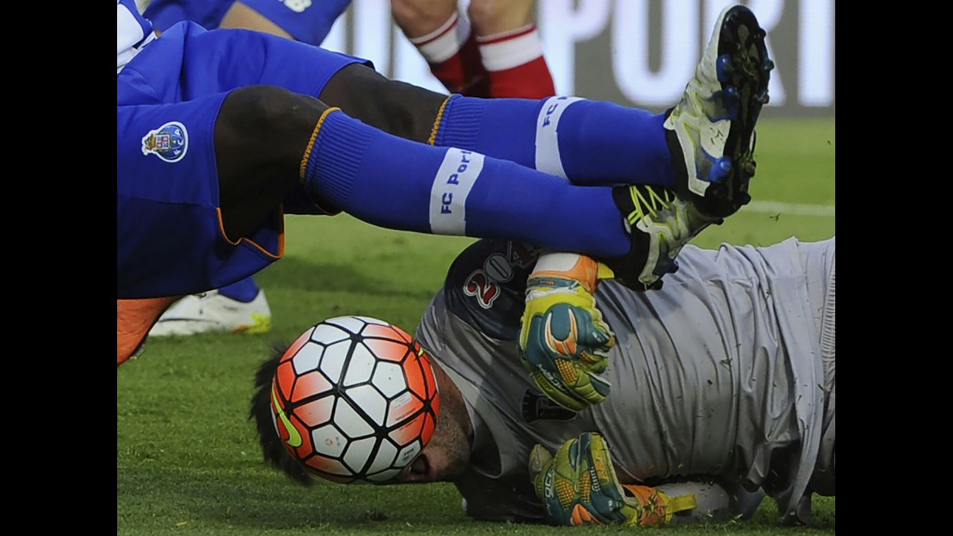 The ball obscures the face of Sporting Braga goalkeeper Carlos Marafona as he falls next to Porto's Silvestre Varela on Sunday, May 22. Braga would go on to win the Portuguese Cup on penalty kicks.